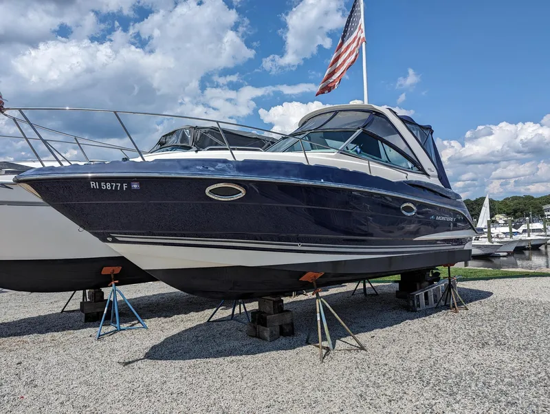 Slide: The Image of 2013 Monterey 280 Sport Yacht on stands, American flag, blue sky background. - 3