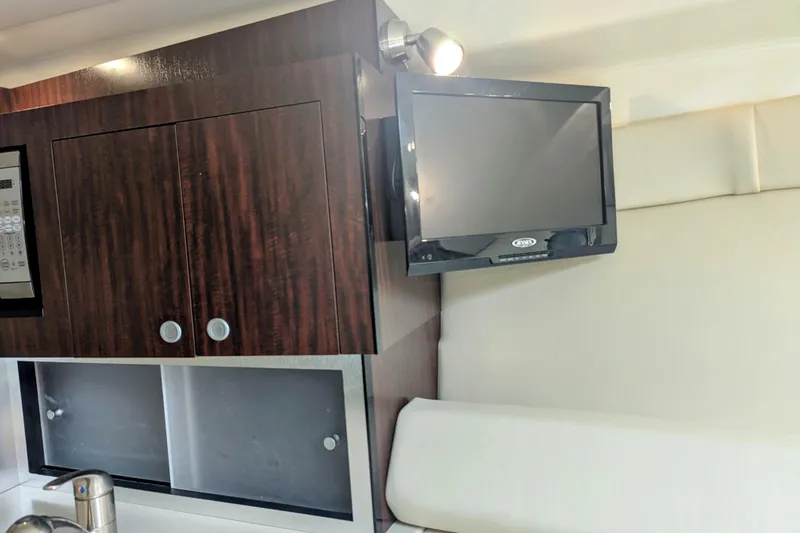 Slide: The Image of Interior of 2013 Monterey 280 Sport Yacht with TV and wooden cabinetry. - 30
