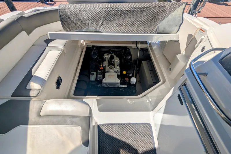 Slide: The Image of 2013 Monterey 280 Sport Yacht engine compartment with open hatch, showcasing interior details. - 35