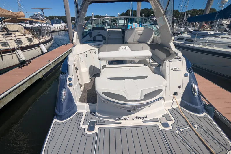 Slide: The Image of 2013 Monterey 280 Sport Yacht docked at marina, rear view with seating area. - 5
