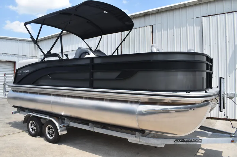 Slide: The Image of 2026 Lowe SF 212 WT Sport Fish pontoon boat on trailer, black exterior, parked outdoors. - 1
