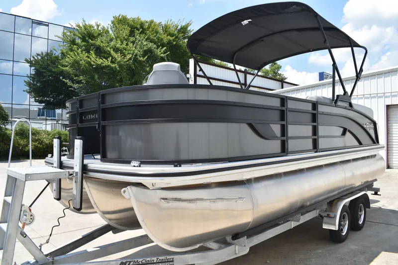 Slide: The Image of 2026 Lowe SF 212 WT Sport Fish pontoon boat on trailer, with canopy, outdoors. - 10