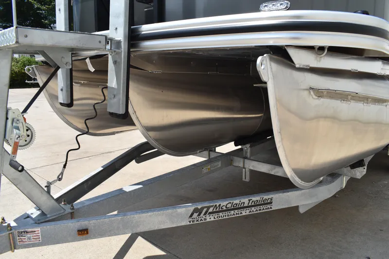 Slide: The Image of 2026 Lowe SF 212 WT Sport Fish pontoon on McClain trailer, close-up view. - 11