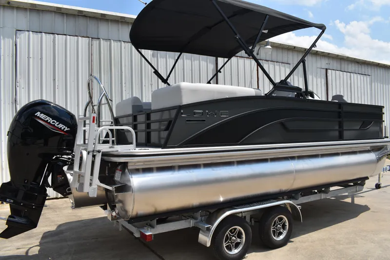 Slide: The Image of 2026 Lowe SF 212 WT Sport Fish pontoon boat with Mercury outboard motor on trailer. - 2
