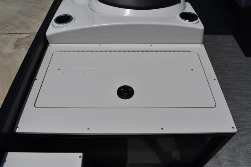 Slide: The Image of 2026 Lowe SF 212 WT Sport Fish boat deck with storage compartment and cup holders. - 25