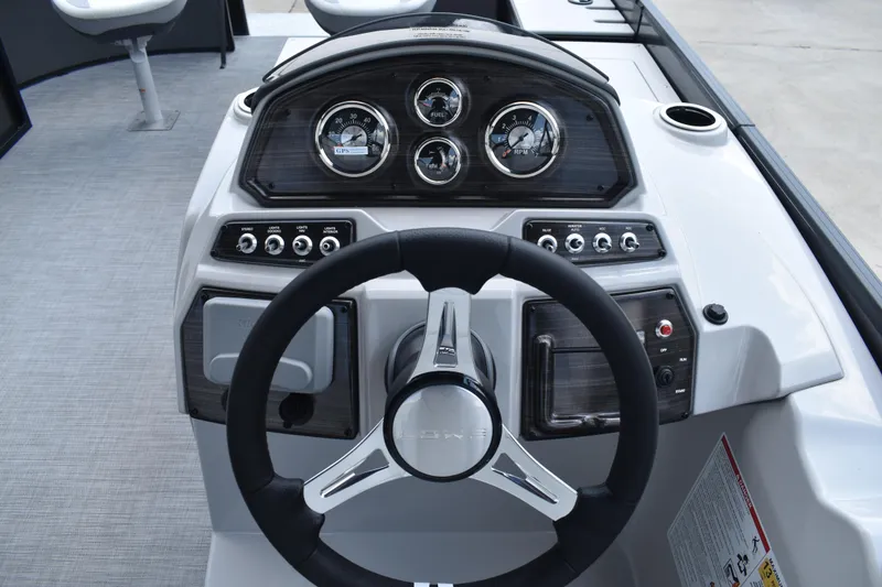 Slide: The Image of 2026 Lowe SF 212 WT Sport Fish dashboard with steering wheel and gauges. - 34