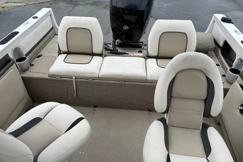 Slide: The Image of 2014 Crestliner 1850 Sportfish boat interior with beige seating and cup holders. - 10