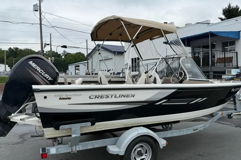 Slide: The Image of 2014 Crestliner 1850 Sportfish boat on trailer with Mercury outboard motor. - 4