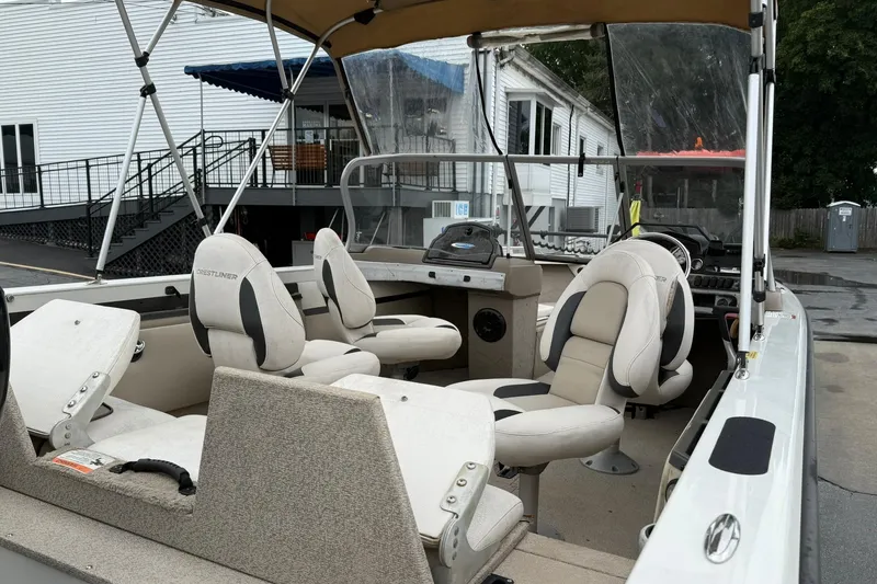 Slide: The Image of 2014 Crestliner 1850 Sportfish boat interior with seating and dashboard view. - 6