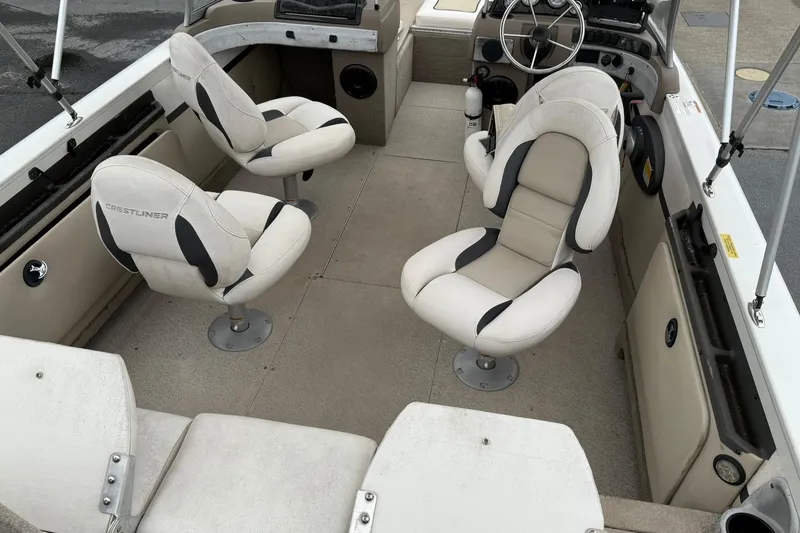 Slide: The Image of 2014 Crestliner 1850 Sportfish boat interior with swivel seats and steering console. - 7