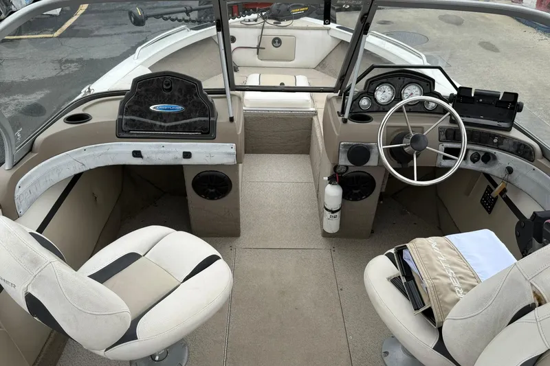 Slide: The Image of 2014 Crestliner 1850 Sportfish boat interior with steering wheel and seating. - 8