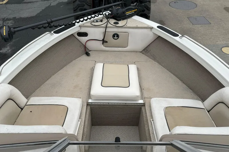 Slide: The Image of 2014 Crestliner 1850 Sportfish boat interior with seating and trolling motor. - 9