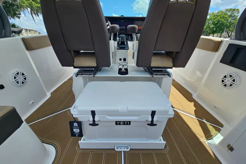 Slide: The Image of 2026 Monterey Elite 25 OB boat interior with Yeti cooler and seating. - 10