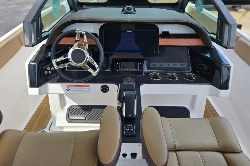 Slide: The Image of 2026 Monterey Elite 25 OB boat dashboard with modern steering and digital display. - 12