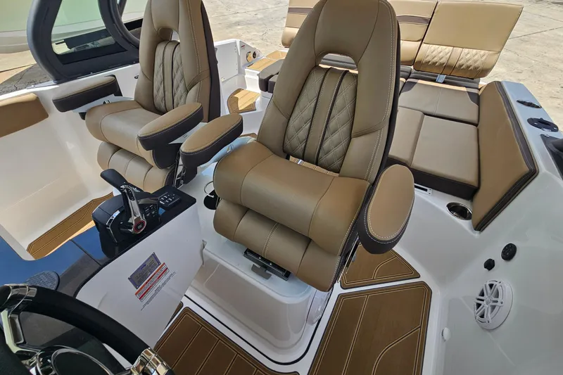 Slide: The Image of Luxurious interior of 2026 Monterey Elite 25 OB boat with plush seating and modern controls. - 13