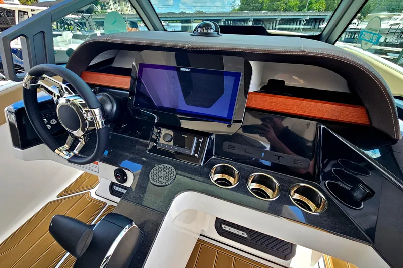 Slide: The Image of 2026 Monterey Elite 25 OB dashboard with modern steering and touchscreen display. - 14