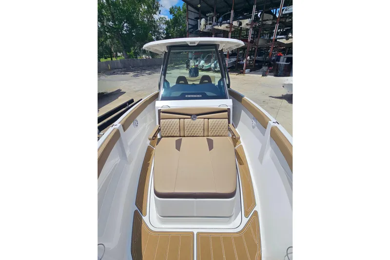 Slide: The Image of 2026 Monterey Elite 25 OB boat with tan seating and sleek design. - 17