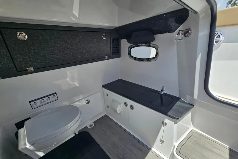 Slide: The Image of 2026 Monterey Elite 25 OB boat interior with modern bathroom amenities. - 21