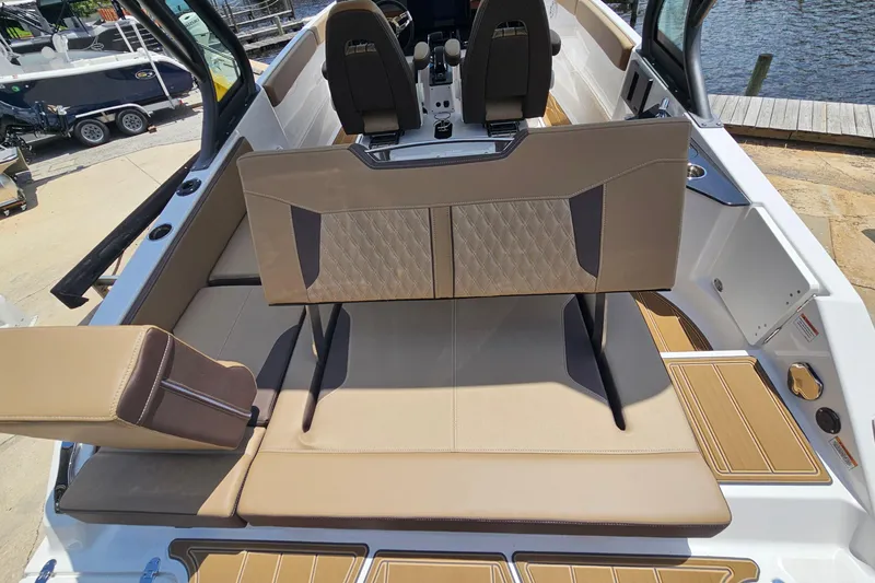 Slide: The Image of 2026 Monterey Elite 25 OB boat interior with tan seating and modern design. - 25