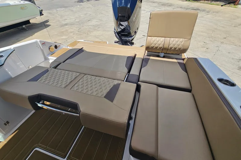 Slide: The Image of 2026 Monterey Elite 25 OB boat interior with luxurious tan seating and modern design. - 26