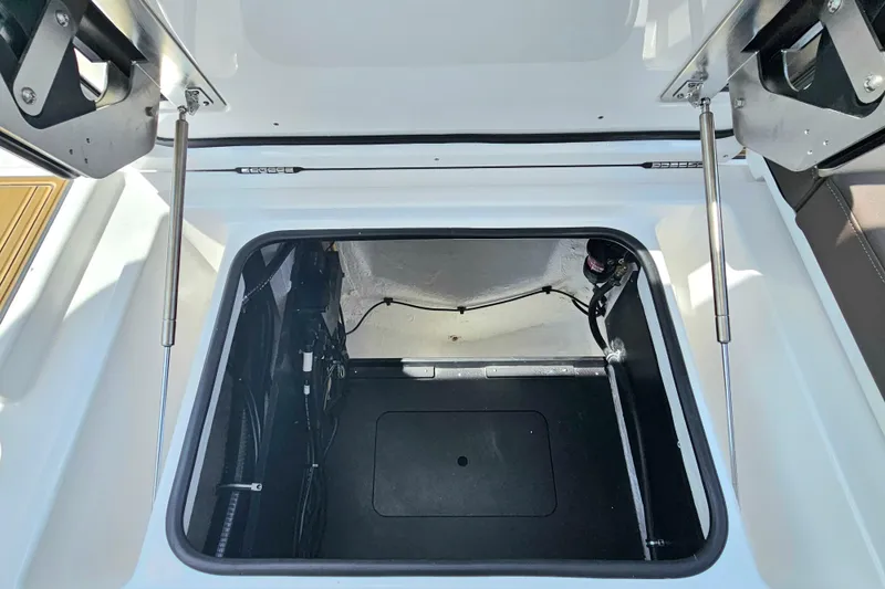 Slide: The Image of Open storage compartment in 2026 Monterey Elite 25 OB boat. - 28