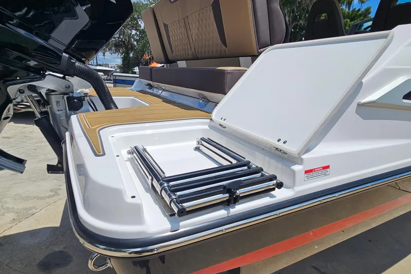 Slide: The Image of 2026 Monterey Elite 25 OB boat with foldable swim ladder and cushioned seating. - 30