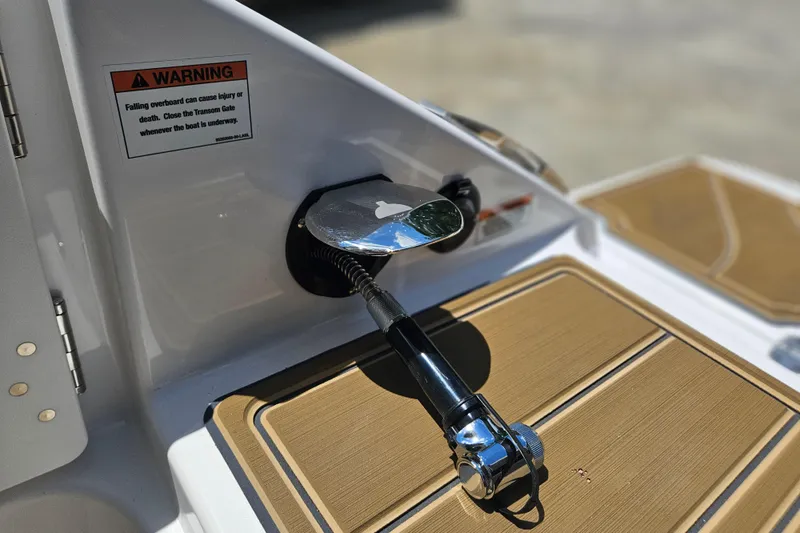 Slide: The Image of 2026 Monterey Elite 25 OB boat detail with warning sign and deck shower. - 31