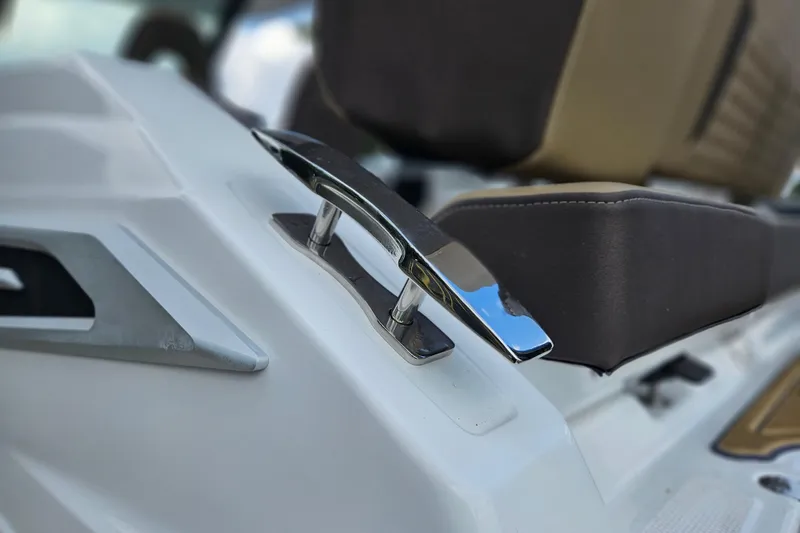 Slide: The Image of Close-up of 2026 Monterey Elite 25 OB boat's sleek chrome handle and seating. - 32