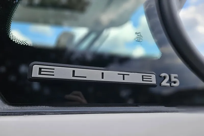 Slide: The Image of 2026 Monterey Elite 25 OB logo on boat window, close-up view. - 33