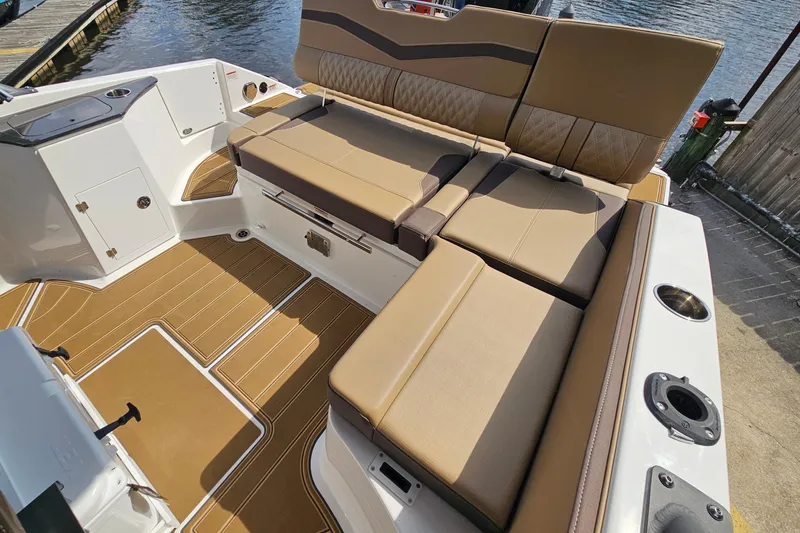 Slide: The Image of 2026 Monterey Elite 25 OB boat interior with tan seating and sleek design. - 8
