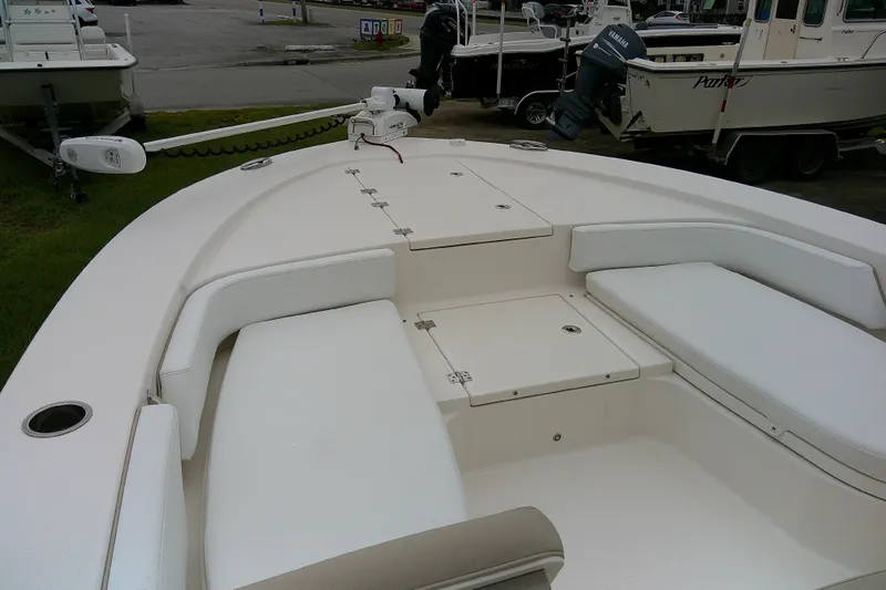 Slide: The Image of 2021 Robalo 246 Cayman boat interior with cushioned seating and storage compartments. - 13