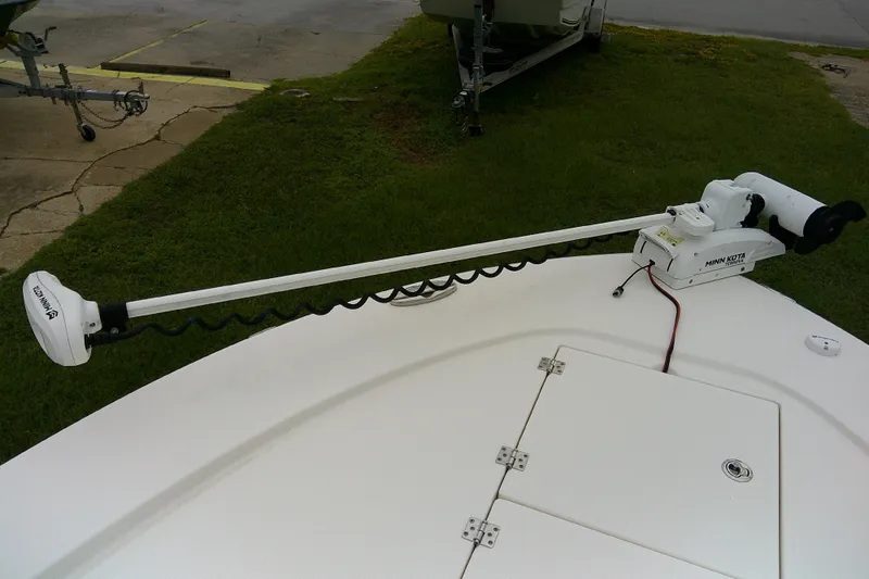 Slide: The Image of 2021 Robalo 246 Cayman boat with Minn Kota trolling motor on deck. - 16