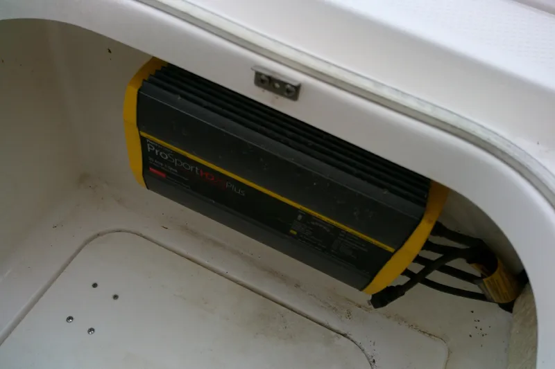 Slide: The Image of Battery charger in a 2021 Robalo 246 Cayman boat compartment. - 20