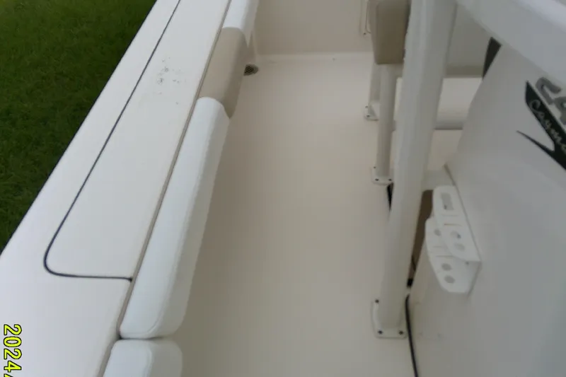 Slide: The Image of 2021 Robalo 246 Cayman boat interior with white seating and console. - 22