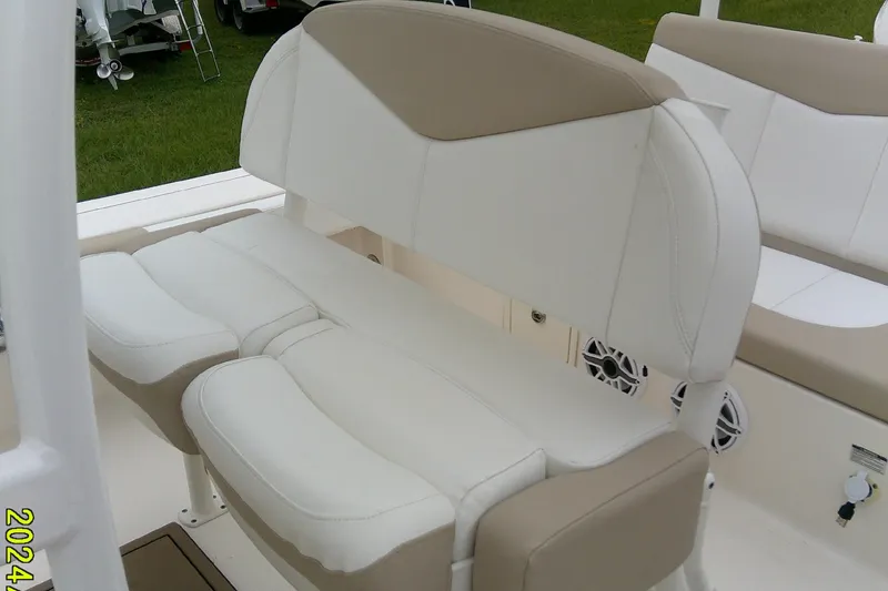 Slide: The Image of 2021 Robalo 246 Cayman boat seating with beige and white upholstery. - 24