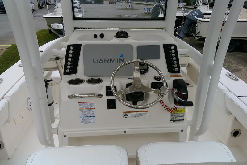Slide: The Image of 2021 Robalo 246 Cayman boat dashboard with Garmin navigation system and steering wheel. - 26
