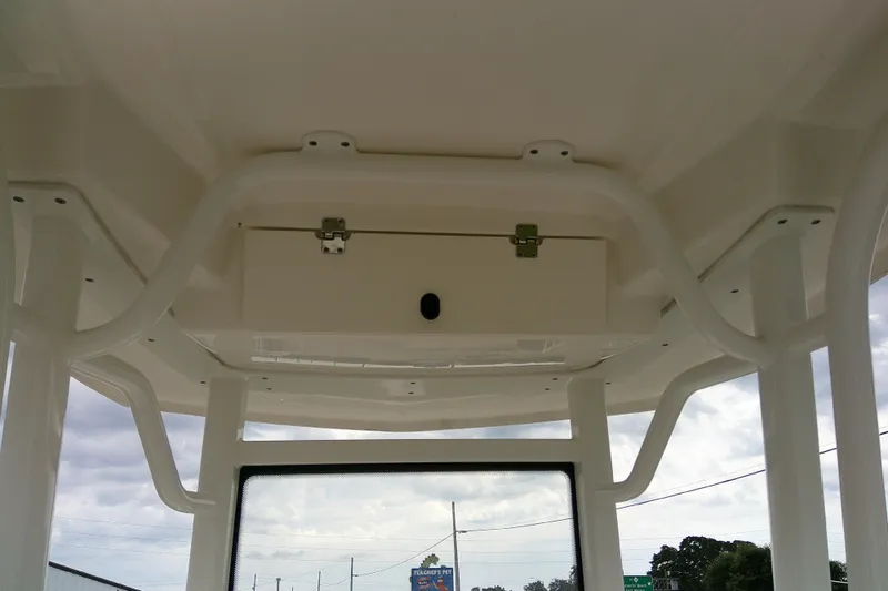 Slide: The Image of 2021 Robalo 246 Cayman boat T-top with storage compartment and rod holders. - 27
