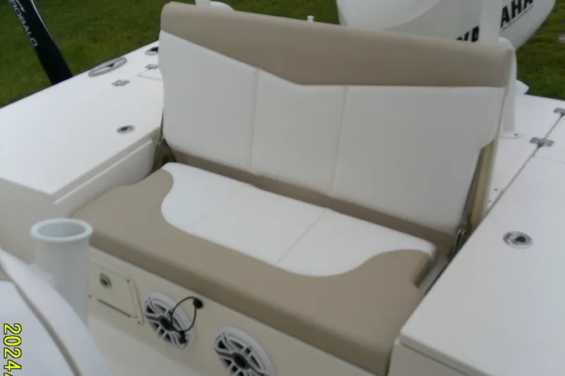 Slide: The Image of 2021 Robalo 246 Cayman boat seat with beige and white upholstery, featuring built-in speakers. - 31