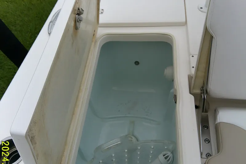 Slide: The Image of Open storage compartment on 2021 Robalo 246 Cayman boat, showing interior details. - 33