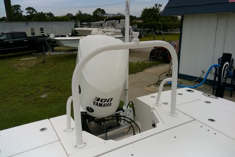 Slide: The Image of 2021 Robalo 246 Cayman with Yamaha 300 engine, parked outdoors. - 35