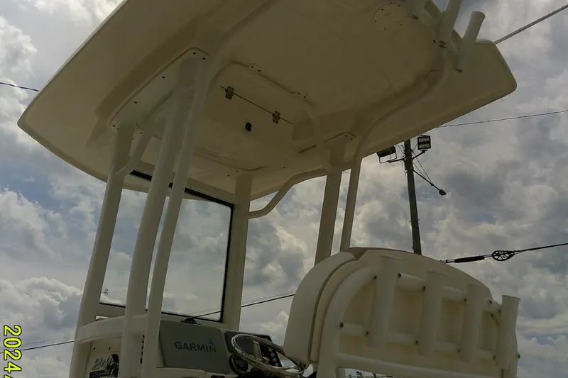 Slide: The Image of 2021 Robalo 246 Cayman boat with T-top and Garmin equipment under cloudy sky. - 42