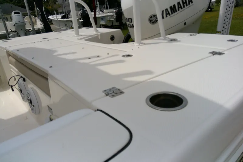 Slide: The Image of 2021 Robalo 246 Cayman boat deck with Yamaha engine, featuring storage compartments. - 43