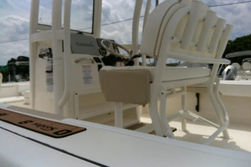 Slide: The Image of 2021 Robalo 246 Cayman boat interior with seating and console, featuring Garmin equipment. - 44