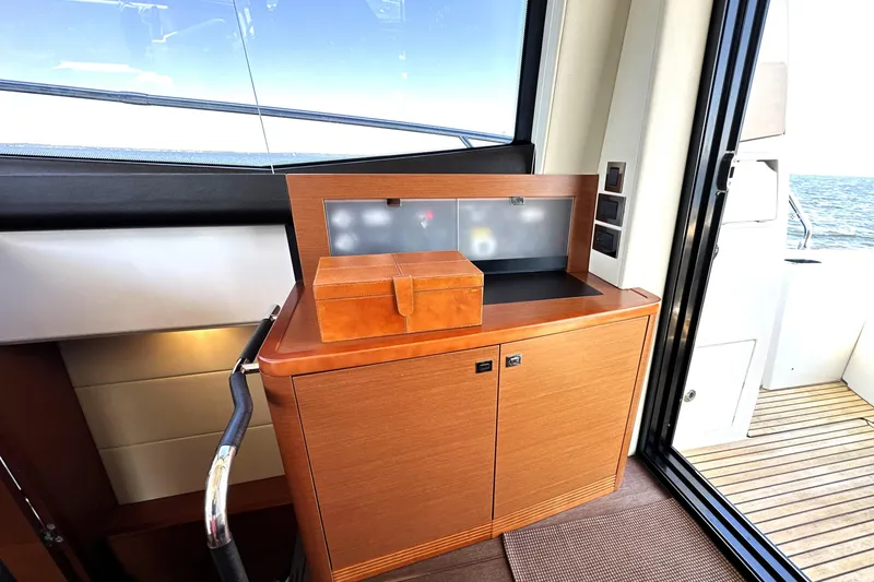Slide: The Image of Interior of 2016 Prestige 500 S yacht with wooden cabinetry and ocean view. - 18