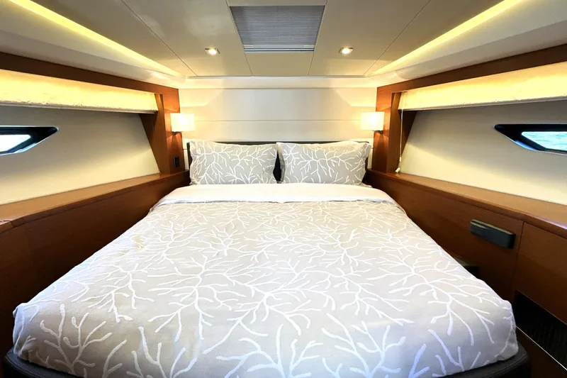 Slide: The Image of Luxurious bedroom interior of 2016 Prestige 500 S yacht with elegant bedding and ambient lighting. - 4
