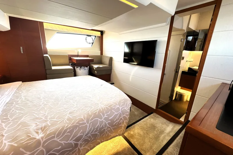 Slide: The Image of Luxurious interior of 2016 Prestige 500 S yacht with modern bedroom and seating area. - 42