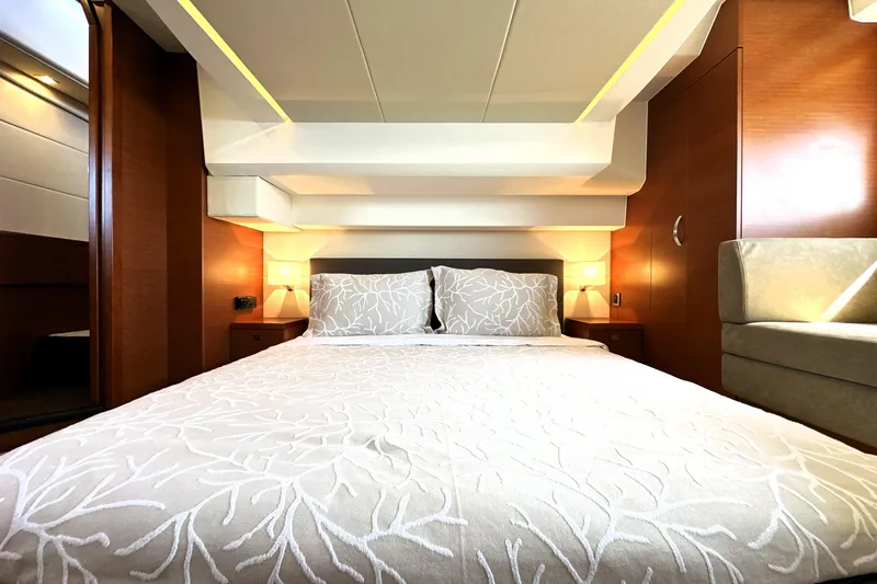 Slide: The Image of Luxurious bedroom interior of 2016 Prestige 500 S yacht with elegant bedding and warm lighting. - 43