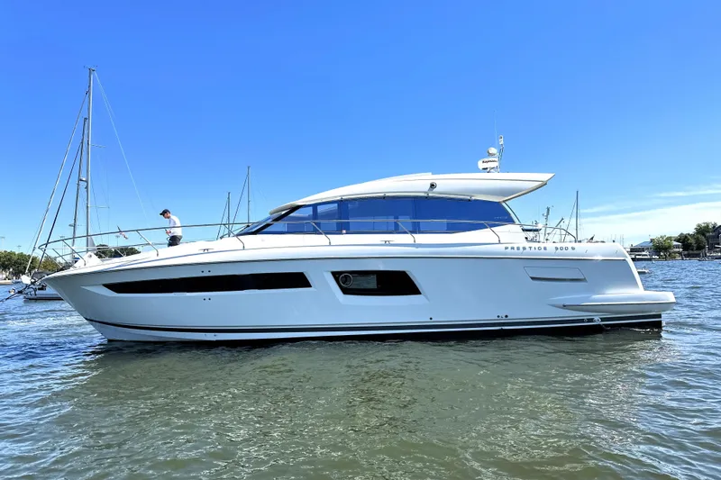 Slide: The Image of 2016 Prestige 500 S yacht on calm water under clear blue sky. - 6