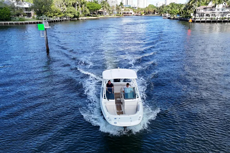 Slide: The Image of 2017 Boston Whaler 230 Vantage cruising on a scenic waterway. - 13
