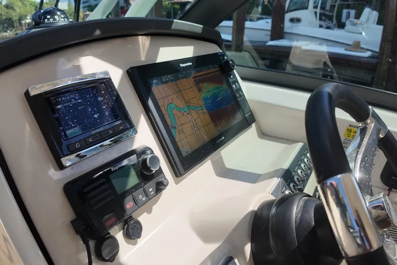 Slide: The Image of 2017 Boston Whaler 230 Vantage dashboard with navigation and control systems. - 15